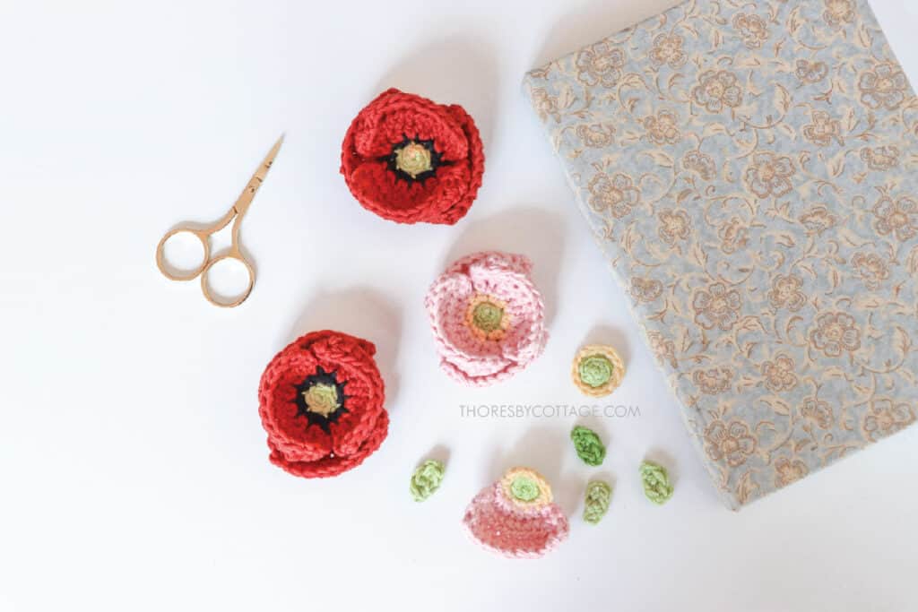 Red and pink crochet poppy flowers and leaves