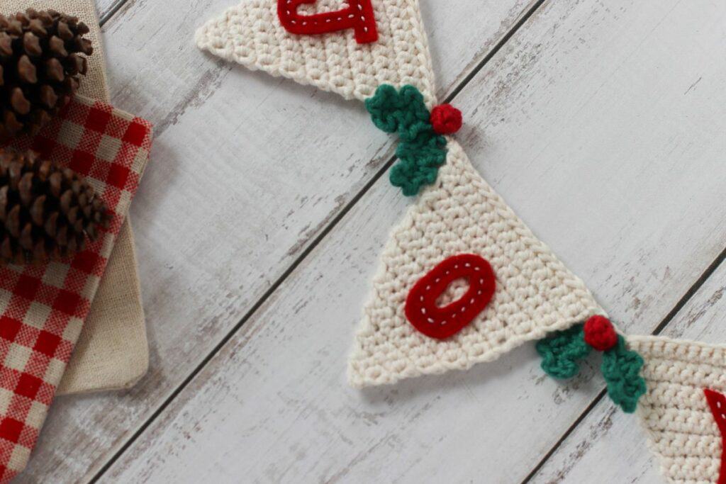 festive beige crochet bunting with mistletoe 