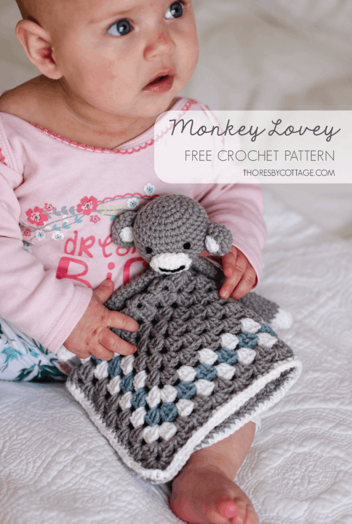 Baby girl holding crochet monkey lovey