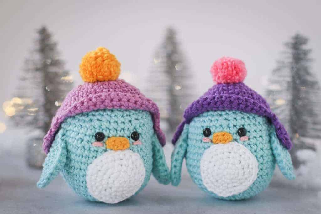 crochet penguin with purple snow hat with pom pom