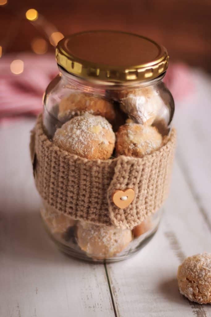 heart shaped wooden button on the back of a crocheted cookie jar wrap