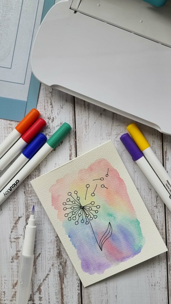 Rainbow card with a line drawn dandelion - made with Cricut watercolor markers